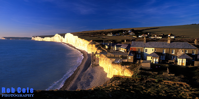 Low winter sun illuminates the cliffs and cottages at Birling Gap