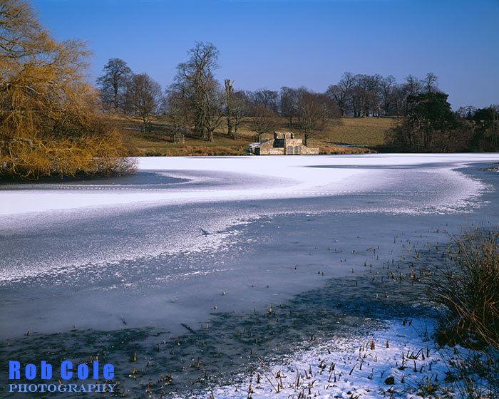 A light dusting of snow lies on the frozen Upper Pond in Petworth Park