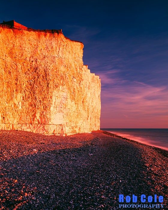 A low winter sun illuminates the chalk cliffs at Birling Gap