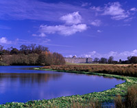 A view of Petworth House across the Upper Lake
