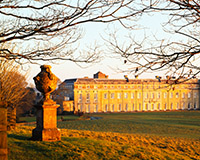 Warm light at sunset illuminates Petworth House on a freezing winter afternoon